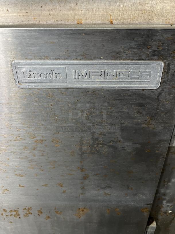 Lincoln Impinger 1451 conveyor oven, stainless steel, liquid propane, 120V, 1-phase, on casters, used condition with rust spots.