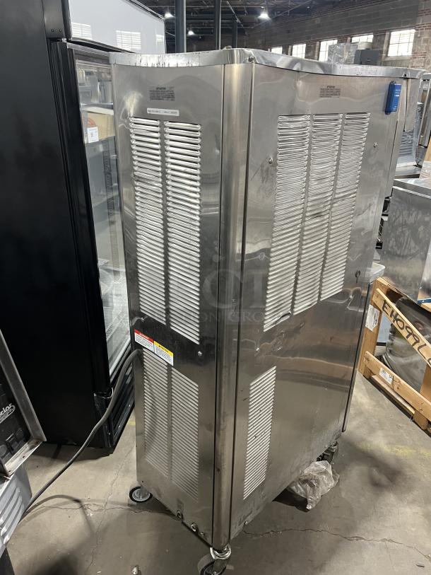 Stoelting O43110912FR stainless steel soft serve machine, 208-240V, 3 phase, on casters, with drip tray.