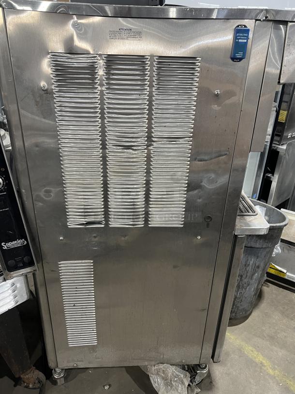 Stoelting commercial stainless steel soft serve machine, model O431-10912F-R, on casters. Features visible vents and drip tray.