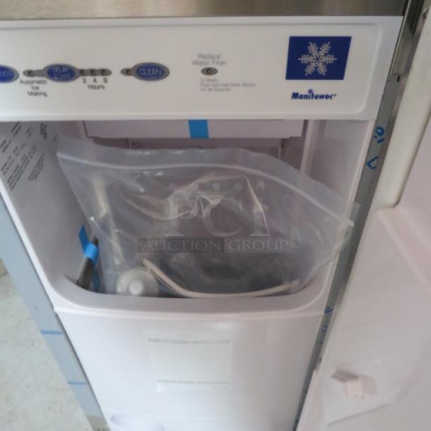 Manitowic under-counter ice maker, model SMS050A002-161, new condition. Features 53lb capacity, 115V, 15x24x33.5 inches.