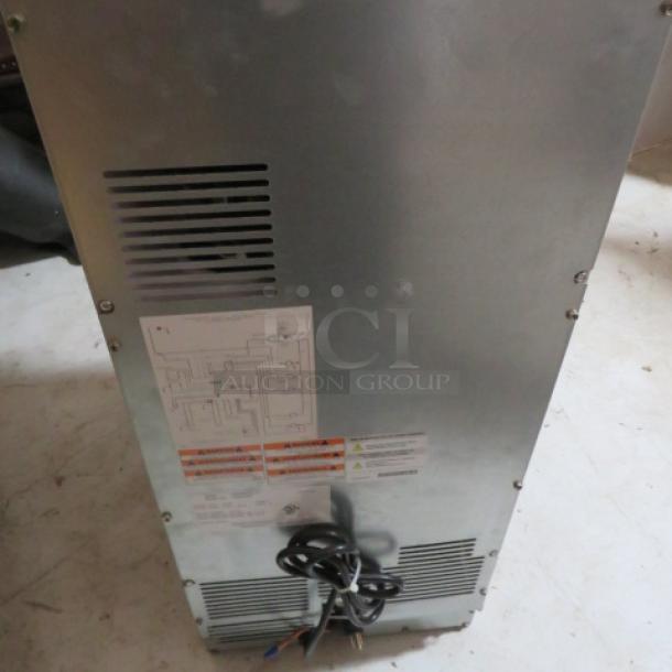 Manitowic under-counter ice maker, model SMS050A002-161, 53lb capacity, new condition, visible labels, 115V, 15x24x33.5 inches.