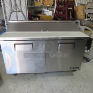 True TSSU-60-16 refrigerated prep table with cutting board, two racks, and casters. Dimensions: 60x30x43 inches. 115V.
