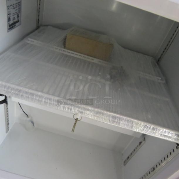 One new Aegis 2-F-5 glass display freezer with three racks, keys, and 115V power. Dimensions 23x25x30.5 inches.