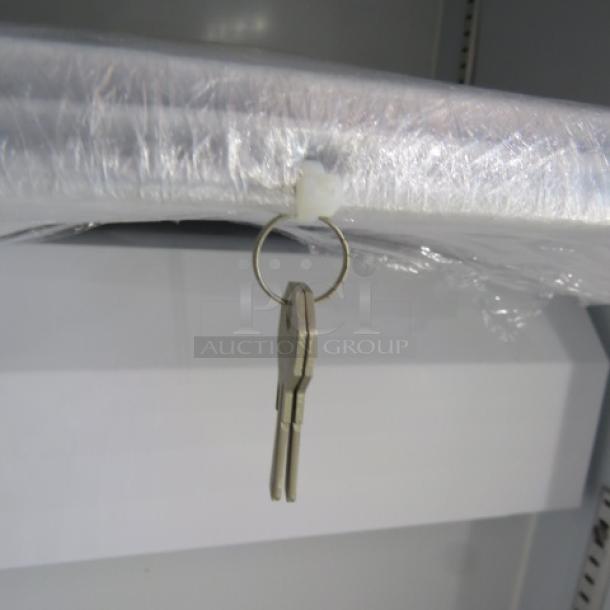 NEW Aegis Model 2-F-5 glass display freezer, 1 door, 3 racks, 115V, 23x25x30.5 inches, includes keys, plastic wrapped.