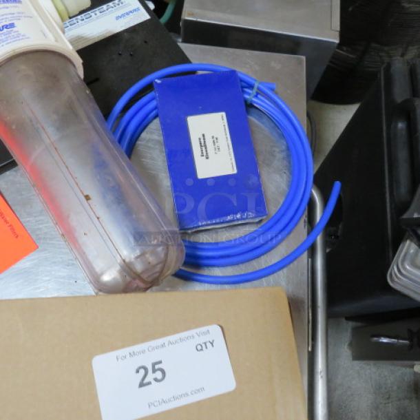 EVERPURE Water Filtration System, includes transparent filter housing, blue tubing, and parts. Some signs of use visible.