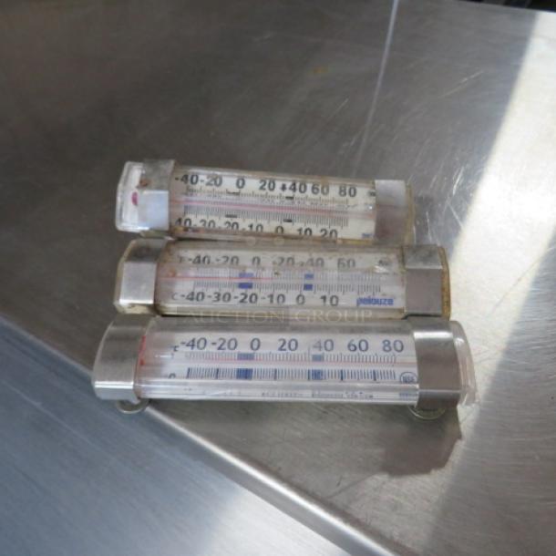Assorted thermometers, three pieces, marked Pelouze. Clear casing, temperature range -40 to 80 degrees. Used condition.