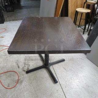 Solid wooden table with 1.5-inch thick top, pedestal base, 36x30x30 inches, dark finish, excellent condition.