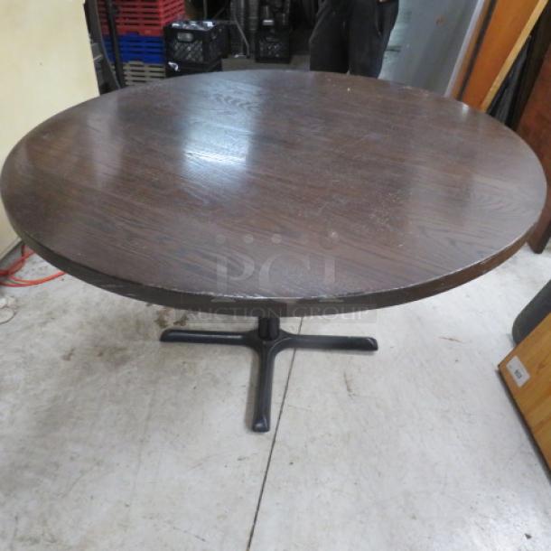 Solid wooden table top on pedestal base, 1.5 inches thick, dimensions 52x52x30 inches, in good condition.