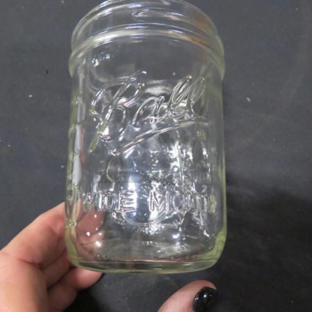 Clear pint-size Ball wide mouth Mason jar, embossed logo, excellent condition, ideal for storage or decor.