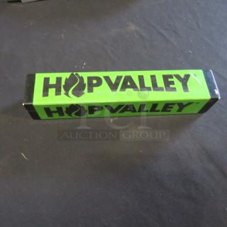 Hop Valley beer tap handle, green with black logo and text, rectangular shape, excellent condition.