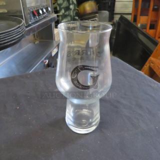 Clear glass beer glass featuring a "G" logo. New condition, sleek design, perfect for collectors or beer enthusiasts.