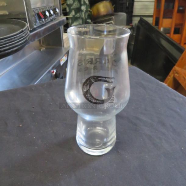 Clear beer glass with "G" logo and details, new condition. Unique shape for enhanced taste experience.