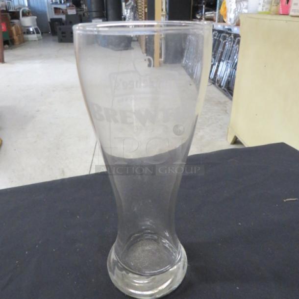 XL Pilsner beer glass with "Brew" engraving, model 12XBID. Clear glass, good condition, ideal for beer enthusiasts.