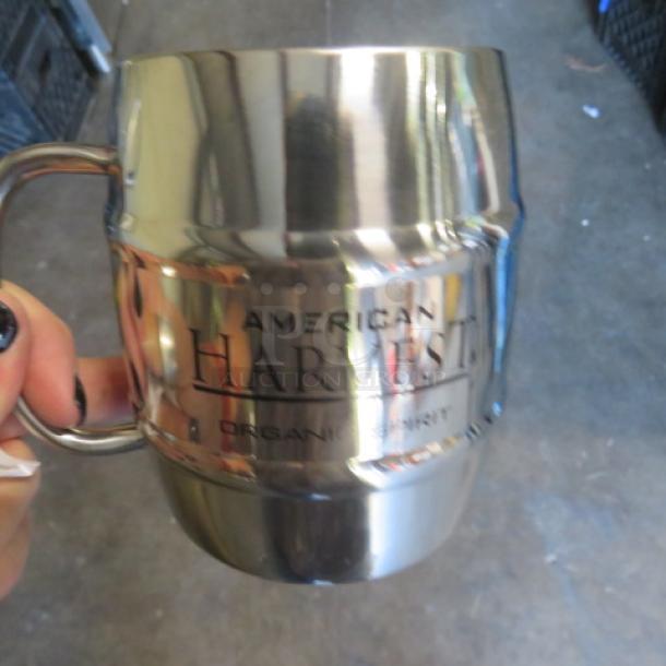 Stainless steel mug with "American Harvest" logo. New condition, ideal for mule cocktails. Durable and sleek design.