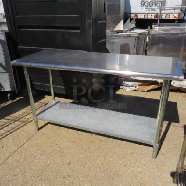 Stainless steel table with under shelf, measures 60x24x35 inches, in good condition, suitable for commercial use.
