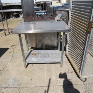 Stainless steel table with under shelf, size 36x24x33.5 inches, used condition, surface rust on legs.