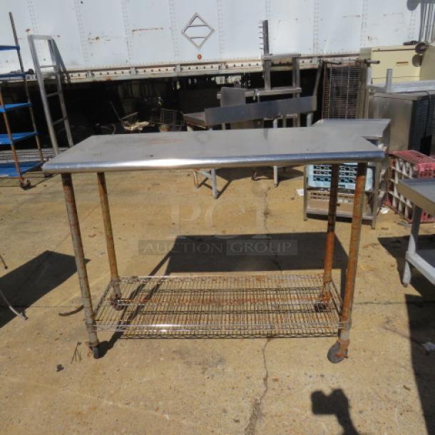 Stainless steel table with Metro under shelf, 49.5x24x39 inches. Used condition, visible rust on legs and shelf.