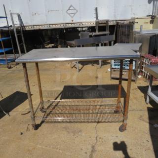 Stainless steel table with Metro under shelf, 49.5x24x39 inches. Used condition, visible rust on legs and shelf.