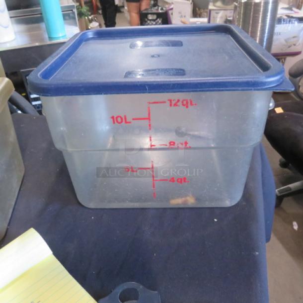 12 Quart food storage container with lid, clear plastic, blue lid, red measurement markings, used condition.