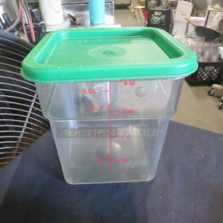 4-quart clear food storage container with green lid, red measurement markings in quarts and liters.