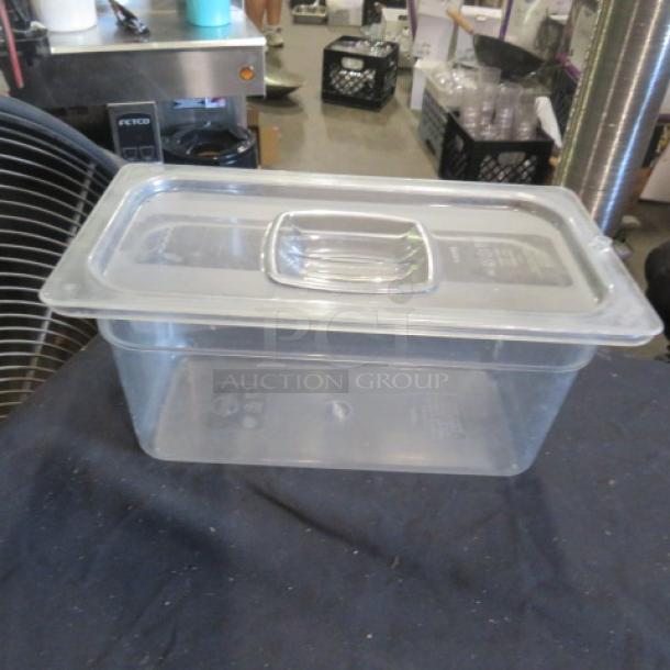 1/3 size, 6-inch deep clear food storage container with lid, in good condition. Ideal for kitchen organization.
