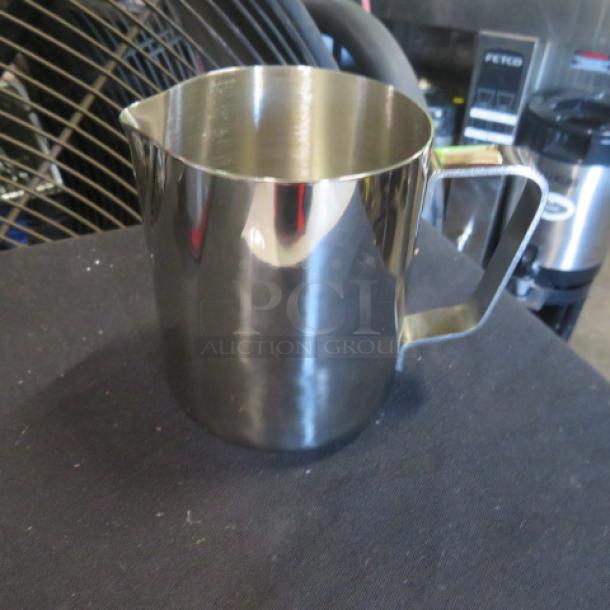 Stainless steel 12oz frothing pitcher, new condition, with a smooth finish and ergonomic handle.