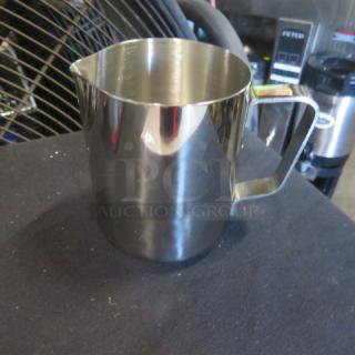 Stainless steel 12oz frothing pitcher, new condition, with a smooth finish and ergonomic handle.