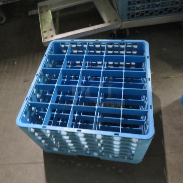Blue 25-hole dishwasher rack, used condition. Sturdy plastic build, open grid design, suitable for commercial dishwashers.
