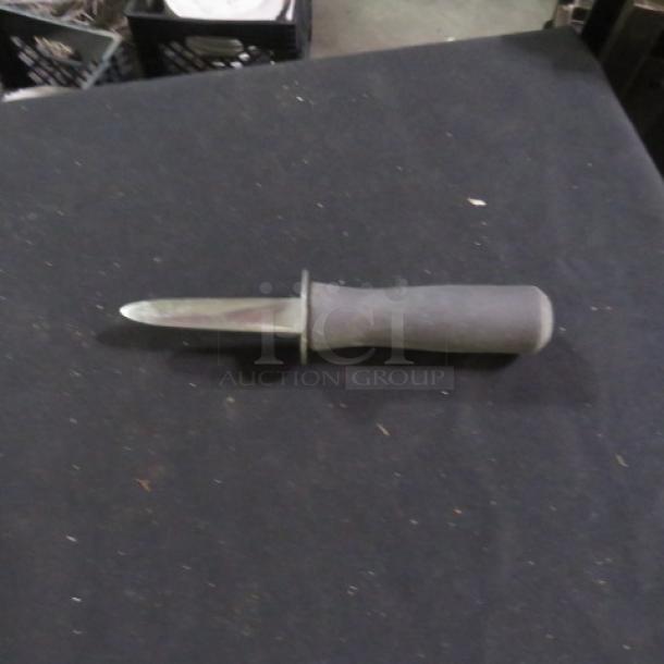 Oyster knife with a stainless steel blade and ergonomic black handle. Slightly used condition. Ideal for shucking oysters.