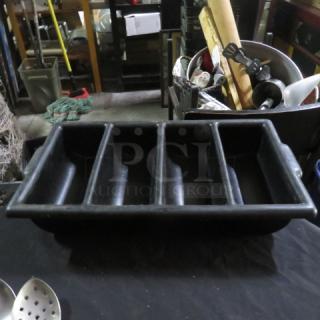 Black flatware holder with five compartments, sturdy condition, used for organizing utensils. No visible markings.