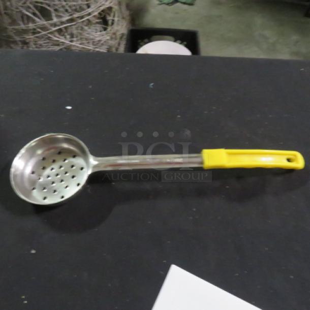 5oz perforated spoodle with yellow handle, stainless steel, excellent condition, ideal for draining and serving.