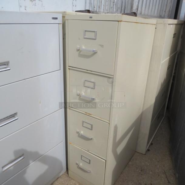 HON 4-drawer file cabinet, beige, 15x25x42 inches, used condition with visible rust at top, sturdy metal construction.