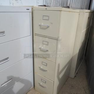 HON 4-drawer file cabinet, beige, 15x25x42 inches, used condition with visible rust at top, sturdy metal construction.
