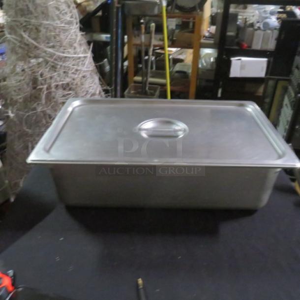 Full size 6-inch deep hotel pan with lid, stainless steel, excellent condition, ideal for food service use.