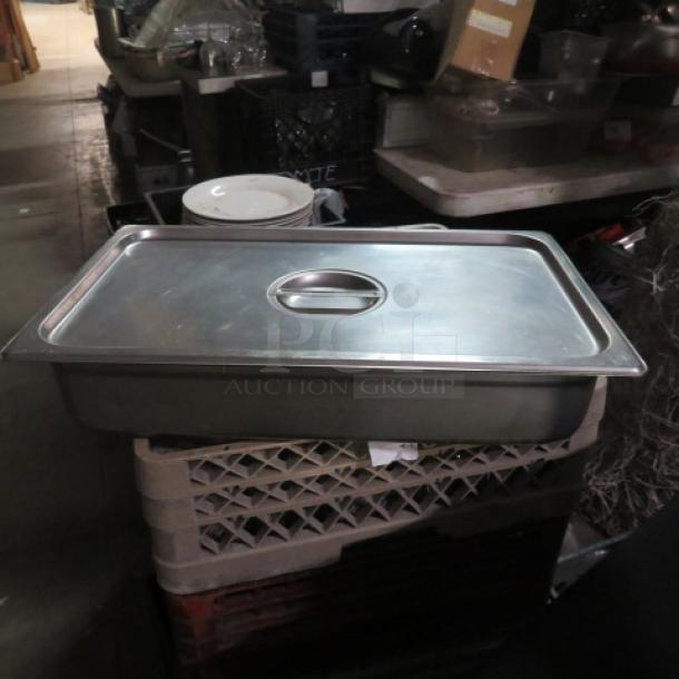 Full-size hotel pan, 4-inch deep, with lid. Stainless steel, good condition. Ideal for catering or food service use.