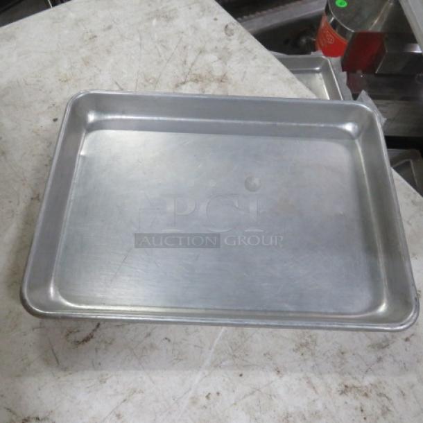 13x9.5 aluminum sheet pan in good condition, showing light scratches. Ideal for baking or roasting.