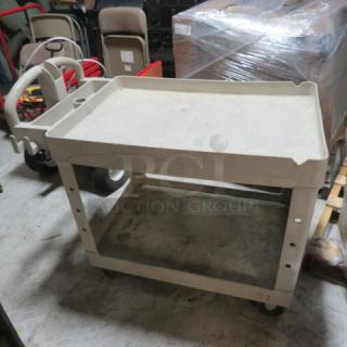 Two-shelf utility cart on casters, sturdy build, light wear. Ideal for storage or transport.