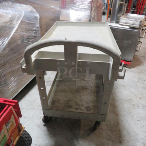 Gray 2-shelf utility cart on casters, sturdy frame, plastic material, ergonomic handle, minor wear, suitable for storage or transport.