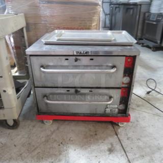 One Vulcan VW2S 2 Drawer Warmer, used, with power cord, 120 Volt, visible brand label, on four wheels.