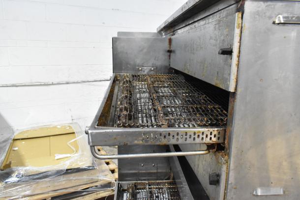 Middleby Marshall PS638G stainless steel commercial conveyor pizza oven, natural gas powered, visible wear, on casters.