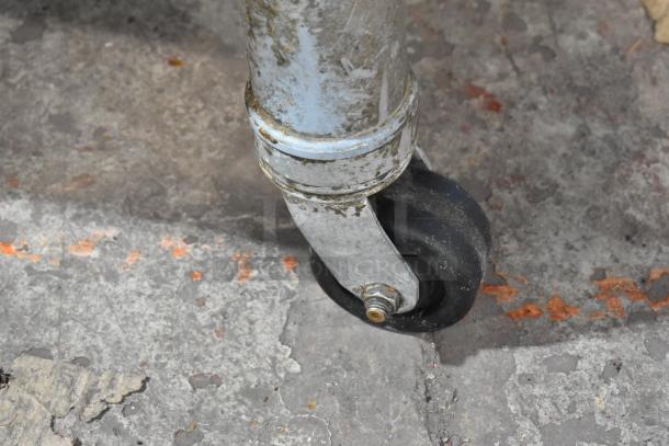 Close-up of a metal commercial caster wheel from a 2021 Middleby Marshall PS638G conveyor pizza oven. Slight wear visible.