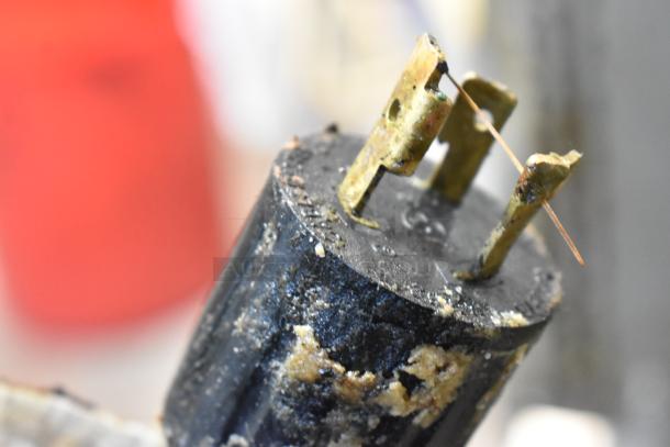 Close-up of a power plug showing visible wear and dirt, possibly related to the Middleby Marshall PS638G pizza ovens.