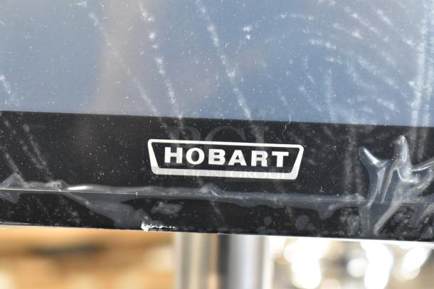Brand new Hobart HTi-SSLSC 2024 metal commercial scale. Features label printer. Visible Hobart logo.