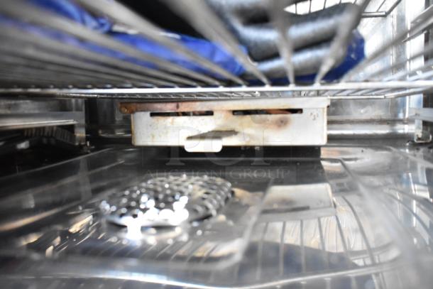 Interior of 2018 Alto Shaam CTP7-20E combi convection oven, stainless steel, showing racks and equipment stand. Some wear visible.