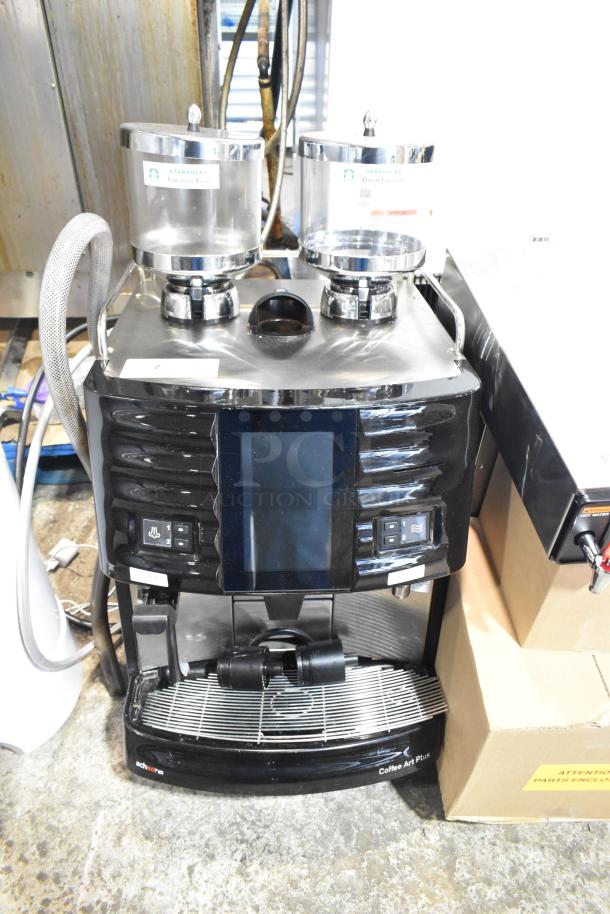 Schaerer Coffee Art Plus automatic espresso machine with dual hoppers, digital display, and commercial-grade metal finish.