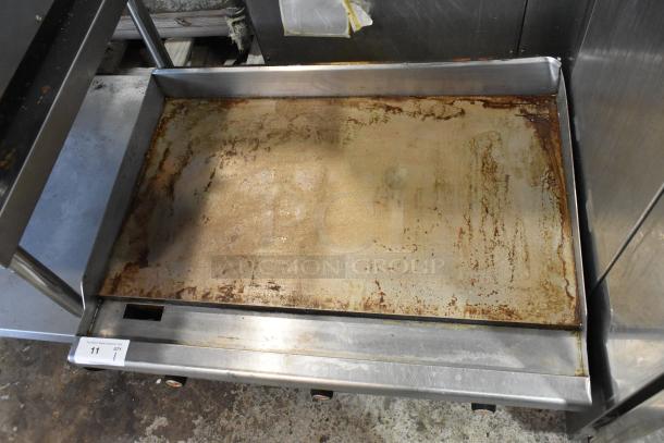 Vulcan VCRG36-T1 stainless steel commercial griddle. Flat top, natural gas. Visible wear, signs of use on surface.
