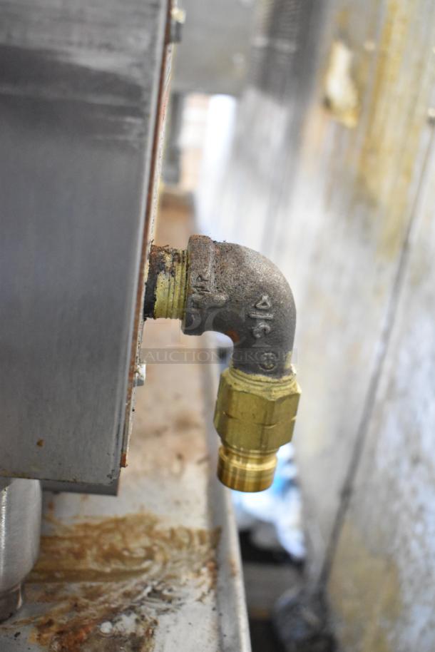 Vulcan VACB36-101 stainless steel commercial charbroiler gas connector, equipment stand, showing minor wear and rust.
