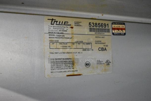 True TA2H-2S warming cabinet label showing model, voltage 115/208-240, 1 phase, 4000 watts, made in USA.