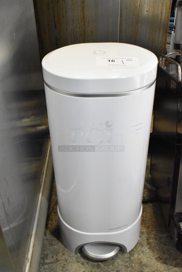 White diaper pail with a foot pedal, slight surface marks, brand "Munchkin" visible at base. Auction label on top.