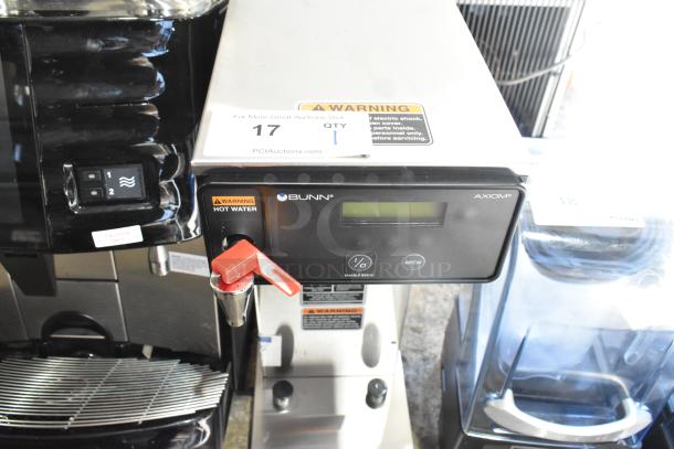 Brand new 2022 Bunn AXIOM-DV-APS stainless steel coffee brewer with hot water dispenser. Visible warning label. 120V, 1 phase.